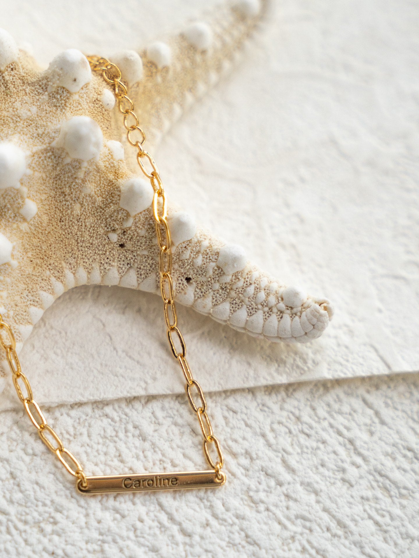 Custom name bracelet on a textured white surface